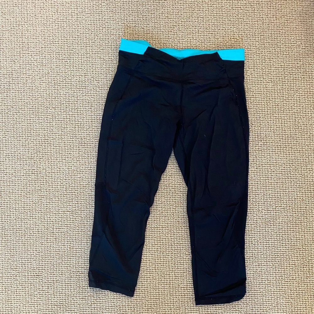 Calvin Klein Cropped Athletic Leggings. Black with blue band at the top.